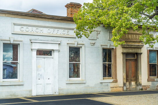 Historic shop fronts along a footpath