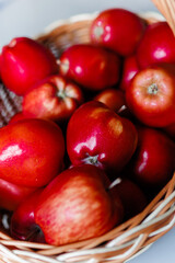 Red apples in a basket on a gray background