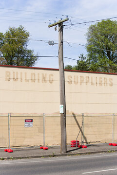 Fenced off wall of old building with faded signage