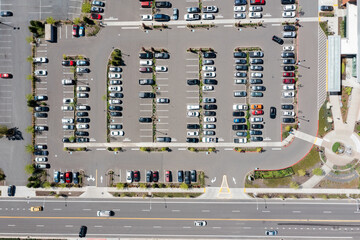 Aerial drone top-down view of a busy and full parking lot at a large medical provider in Beaverton, Oregon, with many parked cars and clearly marked driving lanes