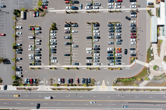 Aerial drone top-down view of a busy and full parking lot at a large medical provider in Beaverton, Oregon, with many parked cars and clearly marked driving lanes