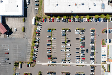 Aerial drone top-down view of a busy and full parking lot at a large medical provider in Beaverton, Oregon, with many parked cars and clearly marked driving lanes © Hrach