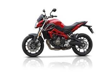 A red and black motorcycle is parked on a white background with a slight reflection below it