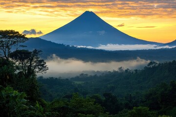 Fototapeta premium Sunrise over Irazu volcano with misty valleys and golden sky