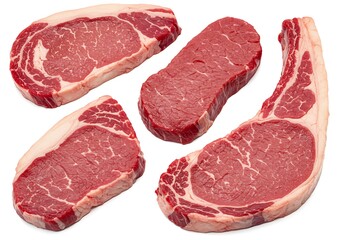 A selection of four raw beef steaks with visible marbling and fat on a plain white background surface