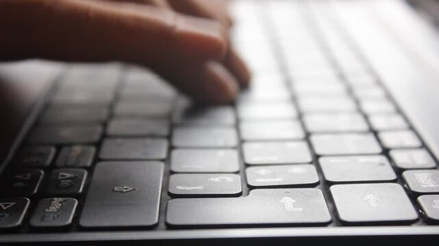 Close-up of Hands Typing on a Laptop Keyboard