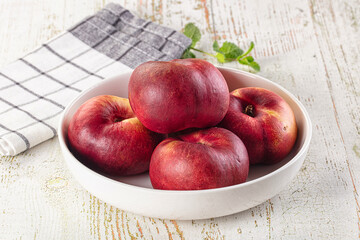 Ripe sweet juicy flat nectarines heap