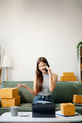 oung woman managing online sales and shipping from a modern home office.