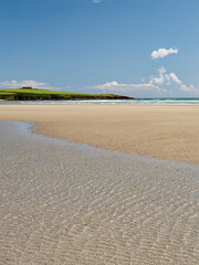 Sun-drenched coastal view. Bask in the beauty of this sun-kissed beach, its soft sand and tranquil waters reflecting the bright sky.