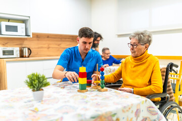 Nurse assisting elderly woman with rehabilitation exercises in nursing home