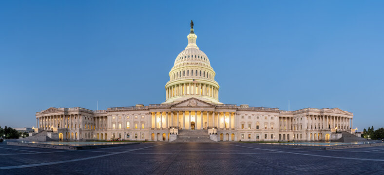 Panorama of the illuminated U.S. Capitol Building in Washington D.C. at dawn