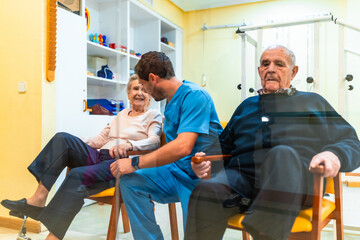 Nurse assisting elderly woman with physical therapy exercises in nursing home