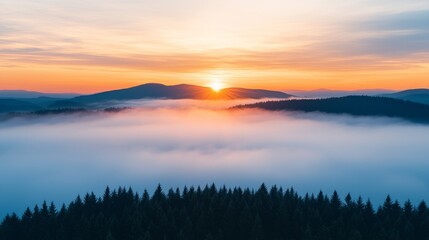 Fototapeta premium Sunrise over misty mountains and forest landscape.