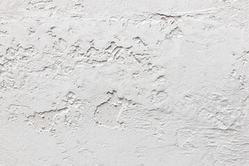 A white wall with a rough texture