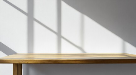 Simple wooden table against a white wall with sun shadows