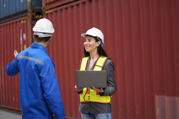 Caucasian man and woman engineer worker working and talking together at container site	