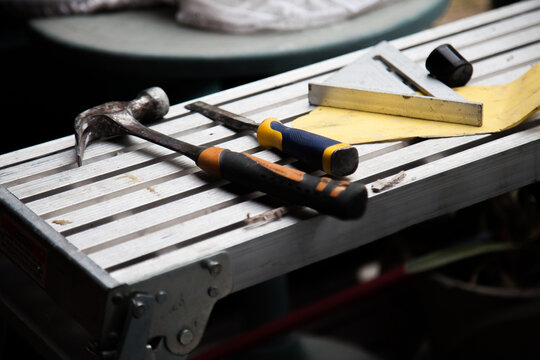 Builders tools and hammer lying on construction site