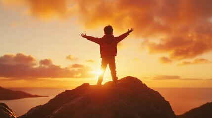 Fototapeta premium A child stands on a rocky peak, arms wide open, embracing life under a stunning sunset view at golden hour.