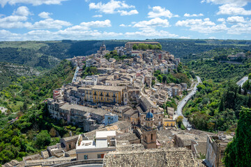 View of the historic center of Ragusa, Sicily, Italy, with its houses cascading over a hill, a...