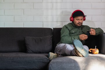 Fototapeta premium adult male with headset checks his cell phone