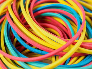 Close-up of multi-colored elastic bands showing off vibrant hues and texture, perfect for office.