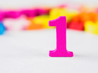 Bold number &ldquo;1&rdquo; close-up. Brightly lit, detailed view. Symbolizes success, leadership being number one.