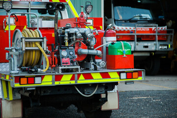 Small country fire truck parked at rural fire station ready for emergency