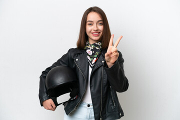 Young Ukrainian woman with a motorcycle helmet isolated on white background smiling and showing...