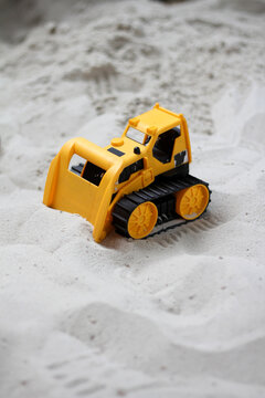 Toy bulldozer in sandpit