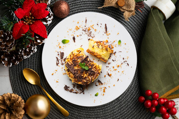 Mango almond and chocolate tartlet. Top view table with christmas decorations.