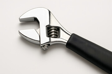 Obraz premium Adjustable Wrench: A close-up shot of a shiny, new adjustable wrench. This essential tool, with its distinctive curved jaws and adjustable mechanism.