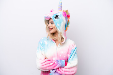 Young Russian woman with unicorn pajamas isolated on white background looking side