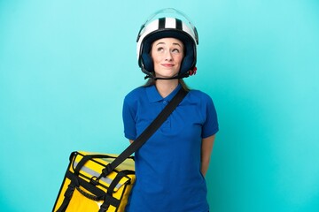 Young caucasian woman with thermal backpack isolated on white background and looking up