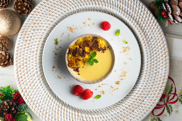 Mango pudding with chocolate and fresh fruit. Top view table with christmas decorations.