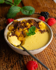 Mango pudding with chocolate and fresh fruit.