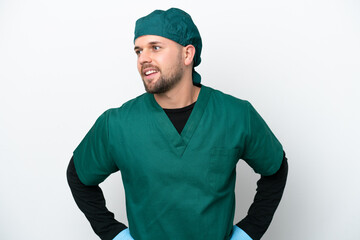 Surgeon in green uniform isolated on white background posing with arms at hip and smiling