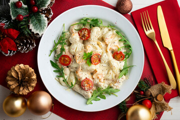 Italian gnocchi salad with cream and arugula. Top view table with christmas decoration.