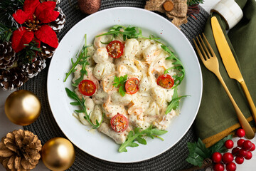 Italian gnocchi salad with cream and arugula. Top view table with christmas decoration.