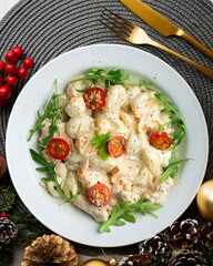 Italian gnocchi salad with cream and arugula. Top view table with christmas decoration.