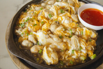 Sizzling Thai Oyster Omelette on Hot Plate. Fresh Oysters, Fluffy Eggs & Crispy Bean Sprouts. Thai Street Food Classic