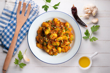 Dish of Italian gnocchi with tomato and meat Bolognese sauce. Top view table.