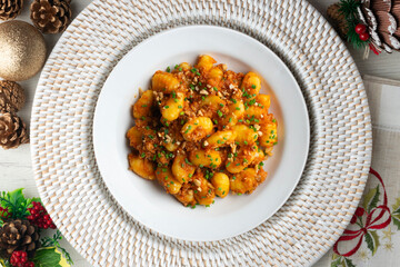 Dish of Italian gnocchi with tomato and meat Bolognese sauce. Top view table with christmas decoration.