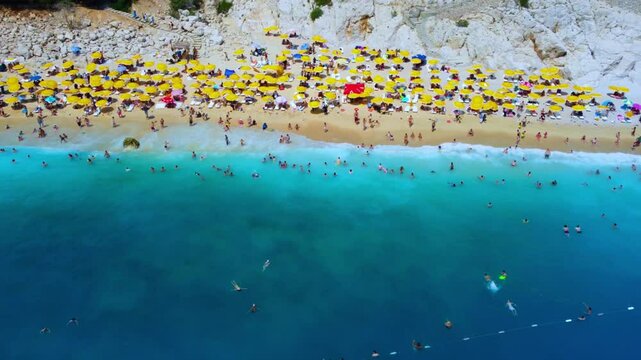Antalya, August 2024:People sunbathe and swim at Kaputaş beach in Turkey on the Mediterranean coast.A beach with turquoise sea waters from a bird's-eye view, between the towns of Kash and Kalkan.Drone
