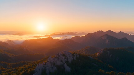 Obraz premium Majestic Sunrise Over Foggy Mountain Ranges Breathtaking Aerial View of Golden Hour Landscape