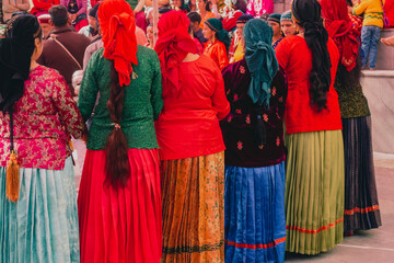 Naklejka premium 31st January 2023, Tehri Garhwal, Uttarakhand, India. Traditional Dance and Music festival during a wedding ceremony in the hills of Uttarakhand. People dancing in colorful traditional attire.