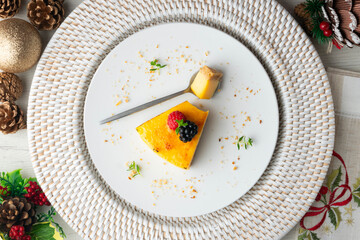 Burnt Catalan custard tart with a biscuit base. Top view of a table with Christmas decorations.