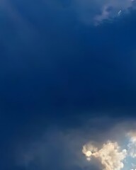 Dramatic Sky: Dark Blue Clouds and Bright Sunlight