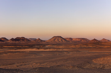 Sunrise lights on the black desert in Egypt
