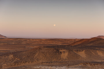 Fototapeta premium Sunrise lights on the black desert in Egypt
