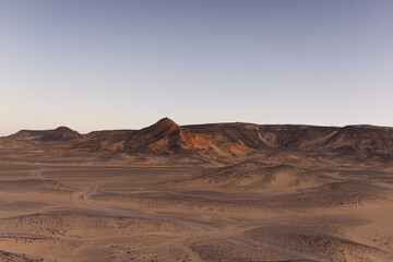Naklejka premium Sunrise lights on the black desert in Egypt